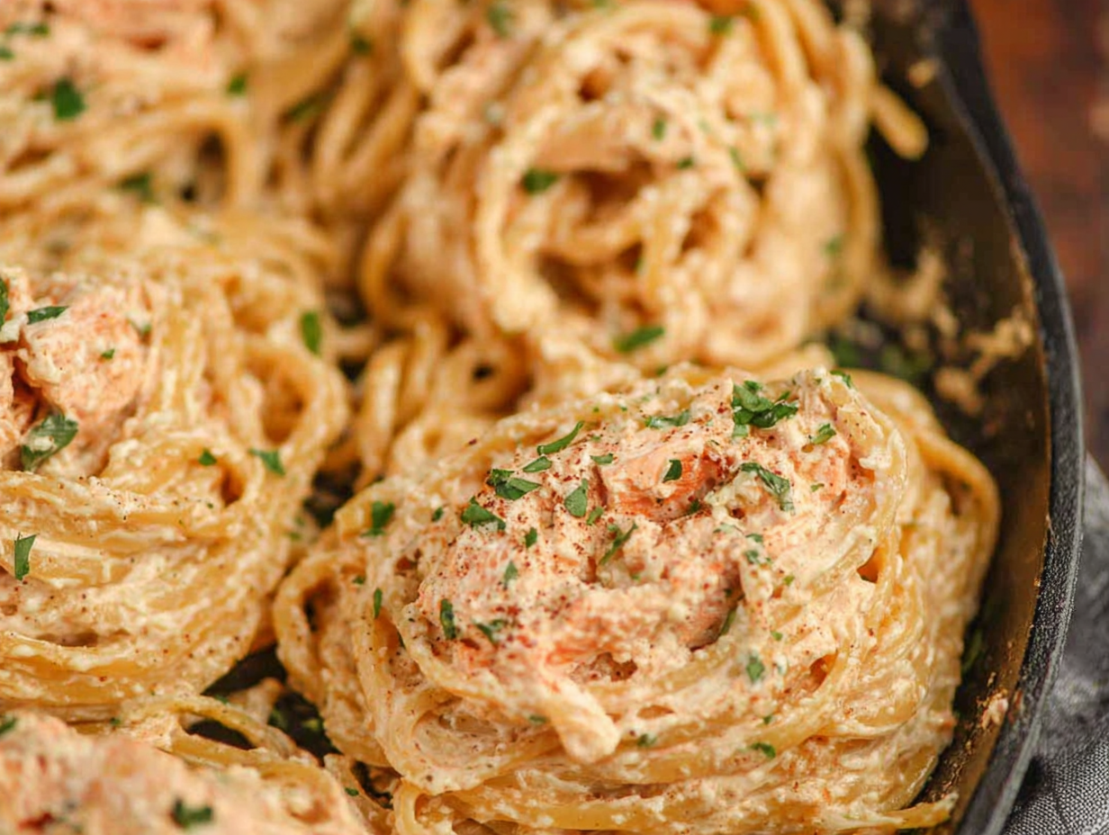 A white bowl filled with creamy Marry Me Pasta, garnished with fresh basil and Parmesan cheese.